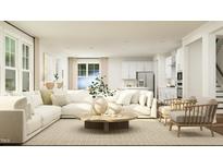 Bright living room features a large sectional sofa and wood coffee table at 1308 Shearwater Way, Knightdale, NC 27545