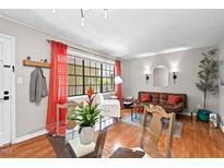 Inviting living area features hardwood floors, a window, and an open dining area at 807 W Trinity Ave # 220, Durham, NC 27701