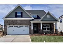 Charming brick home with a two-car garage, covered front porch, and manicured lawn at 1060 Fairhaven Dr # 96, Mebane, NC 27302