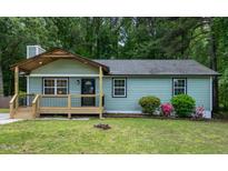 Charming single-story home with a welcoming front porch and fresh green siding at 2704 Ross Rd, Durham, NC 27703