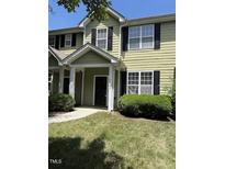 Inviting townhome featuring neutral siding, black shutters, and a well-maintained front lawn at 4429 Log Cabin Dr, Raleigh, NC 27616