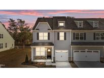 Two-story townhome with gray siding, white trim, and two-car garage at 809 Pryor St, Mebane, NC 27302