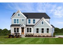 Two-story home with gray siding, stone accents, and a landscaped lawn at 149 Brandy Ml, Pittsboro, NC 27312