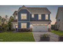 Two-story home with blue siding, white trim, and a two-car garage at 272 White Azalea Way, Homesite 75, Benson, NC 27504