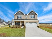 Charming two-story home featuring a two-car garage, well-manicured lawn, and inviting curb appeal at 502 Valentine Ct, Graham, NC 27253