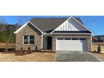 Charming single-story brick home with a two-car garage and well-manicured landscaping at 55 Sawtooth Oak Ln, Youngsville, NC 27596