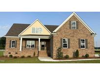 Charming brick home with covered porch and manicured landscaping, offering curb appeal at 7553 Sweetwater Dr, Nashville, NC 27856