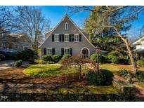 Gray two-story house with black shutters, landscaped lawn, and stone wall at 205 N Boundary St, Chapel Hill, NC 27514