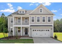 Charming two-story home featuring a covered porch, balcony, and a two-car garage in a desirable neighborhood at 35 Accord Dr, Youngsville, NC 27596