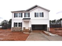 Two story home featuring an attached 2-car garage and a stone-accented facade at 55 Calabria Ct, Franklinton, NC 27525