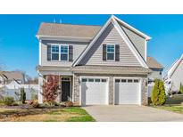 Two-story house with gray siding, two-car garage, and landscaping at 108 Hickock Ct, Mebane, NC 27302