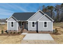 Charming single-story home boasts gray siding, a dark roof, and a tidy, inviting front yard at 9618 Stallings Rd, Spring Hope, NC 27882