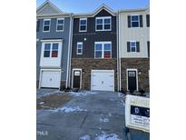 Two-story townhome with attached garage and inviting front entry at 853 Parc Townes Dr # 9, Wendell, NC 27591