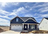 Charming new construction home featuring a grey brick and siding exterior with a two-car garage at 1064 Fairhaven Dr # 95, Mebane, NC 27302