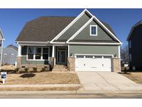 Charming craftsman-style home featuring a two-car garage and inviting front porch at 1600 Maelyn Way, Fuquay Varina, NC 27526