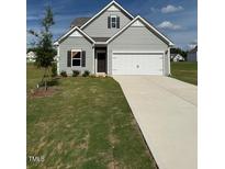 Charming two-story home featuring a two-car garage and well-maintained front lawn at 178 Vili Dr, Broadway, NC 27505
