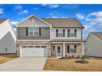 Two story home with gray siding and stone accents at 517 Southwick Pl, Mebane, NC 27302