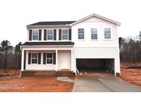 Charming two-story home with a covered front porch and an attached two-car garage at 65 Calabria Ct, Franklinton, NC 27525