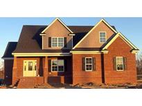 New two-story brick home with a covered front porch and traditional architectural details at 7575 Sweetwater Dr, Nashville, NC 27856