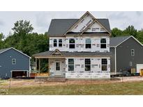 Exterior view of a two-story house with a covered front porch, still under construction at 8816 Melvin St # 15, Willow Springs, NC 27592