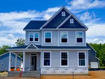 New two-story home with gray siding, dark roof, and well-manicured front yard at 8816 Melvin St # 15, Willow Springs, NC 27592