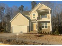 Charming two-story home with a welcoming front porch, attached garage, and beautiful neutral siding at 113 Arundel Dr, Archer Lodge, NC 27527