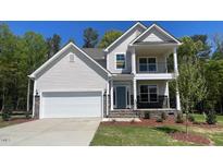 Charming two-story home with a two-car garage, a balcony, and a landscaped yard at 113 Arundel Dr, Archer Lodge, NC 27527