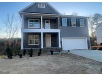 New construction two-story home with gray siding, stone accents, and an attached two-car garage at 118 Arundel Dr, Archer Lodge, NC 27527