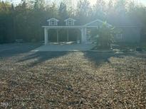 Gray house with carport and spacious yard at 31 Strickland Rd, Smithfield, NC 27577