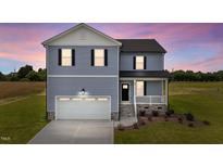 Charming two-story home featuring a covered porch, attached garage, and beautifully landscaped front yard at 55 Diamond Creek Dr, Zebulon, NC 27597