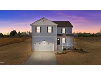 Charming two-story home with a front-facing garage and a welcoming front porch at 55 Diamond Creek Dr, Zebulon, NC 27597