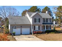 Two-story house with a two-car garage and landscaped yard at 360 Sandy Ridge Rd, Dunn, NC 28334