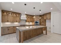 Modern kitchen with large island and ample cabinetry at 617 Darian Woods Dr, Holly Springs, NC 27540