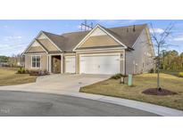 Charming single-Gathering home with a two-car garage, concrete driveway, and well-maintained lawn at 1621 Gatekeeper Ln, Fuquay Varina, NC 27526
