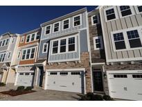 View of new townhomes featuring garages, stone accents, and varied color schemes at 2325 Bay Minette Sta # 548, Apex, NC 27502
