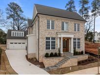 Stunning two-story brick home featuring a prominent front entrance and attached two-car garage at 2642 Marchmont St, Raleigh, NC 27608