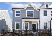 Charming two-story home with a fenced front yard and manicured landscaping at 472 Traditions Grande Blvd # 34, Wake Forest, NC 27587