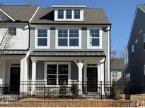 Charming two-story home with gray siding, black door, and black iron fence at 476 Traditions Grande Blvd # 33, Wake Forest, NC 27587