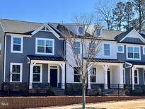 Two-story townhouses with gray and white siding, black accents, and front porches at 486 Traditions Grande Blvd # 28, Wake Forest, NC 27587