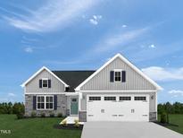 Gray siding two-story house with a white garage door and landscaping at 612 Matthiola Dr, Wendell, NC 27591