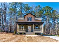 Charming two-story home features a welcoming front porch and beautifully landscaped front yard at 109 Lone Star Dr, Louisburg, NC 27549