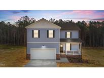 Charming two-story home with blue siding, white trim, and an attached two-car garage at 9133 Phoenix Ct, Spring Hope, NC 27882