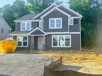 Beautiful two-story home featuring gray siding, white trim, and large windows for plenty of natural light at 1901 Old Bramble Ln # 3, Fuquay Varina, NC 27526