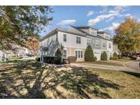 Charming multi-story townhome with a landscaped front yard, sidewalk, and driveway, perfect for comfortable suburban living at 526 Elm Ave, Wake Forest, NC 27587