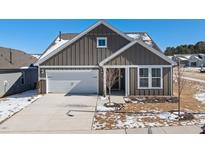 Charming single-Gathering home features a two-car garage, gray siding and a well-manicured front lawn at 1833 Hydrangea Way, Fuquay Varina, NC 27526