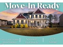 Charming two-story home boasts a covered front porch and manicured lawn, perfect for move-in ready living at 46 Two Belles Ct, Angier, NC 27501