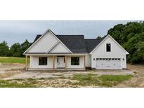 Charming single-story home featuring a covered front porch and attached garage at 6270 River Rd, Fuquay Varina, NC 27526