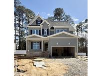Charming two-story home with gray siding, black shutters, and an attached two-car garage at 2625 Silver Gate Ct, Wake Forest, NC 27587