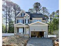 Two-story home showcasing gray siding, black shutters, an attached garage, and a well-manicured lawn at 2625 Silver Gate Ct, Wake Forest, NC 27587