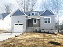 Charming single-Gathering home featuring a craftsman-style elevation, attached garage, and a welcoming entryway at 235 Sequoia Dr, Louisburg, NC 27549
